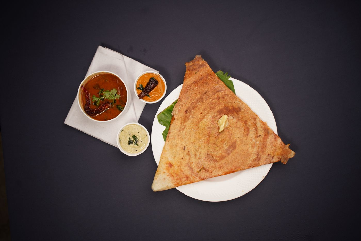 A breakfast of dosa, sambar and chutney, blurred and drained of colour the way memory returns it
